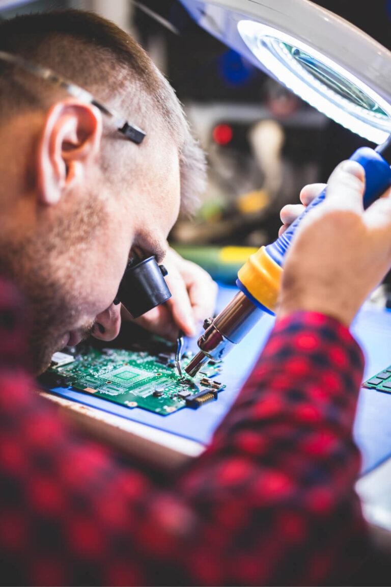 technician-repairing-MacBook-motherboard-at-iphone-service-centre